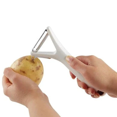 Zyliss Y Peeler using the eye removal tool on a potato