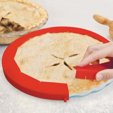 Talisman  Adjustable Pie Shield  showing how it protects a pie crust.