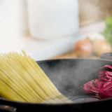 Brainstream Al Dente Pasta Timer lying in a pot of boiling water with pasta