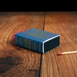 Blue matchbox with 'Slow Burn' text on a wooden surface