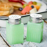 Jadeite 2 oz salt and pepper shakers in front of a meal