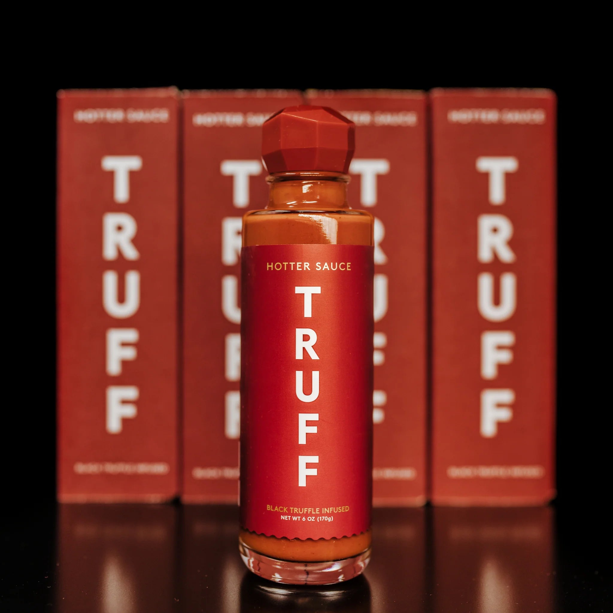 Truff Hotter Sauce Bottle with Truff Boxes in the background