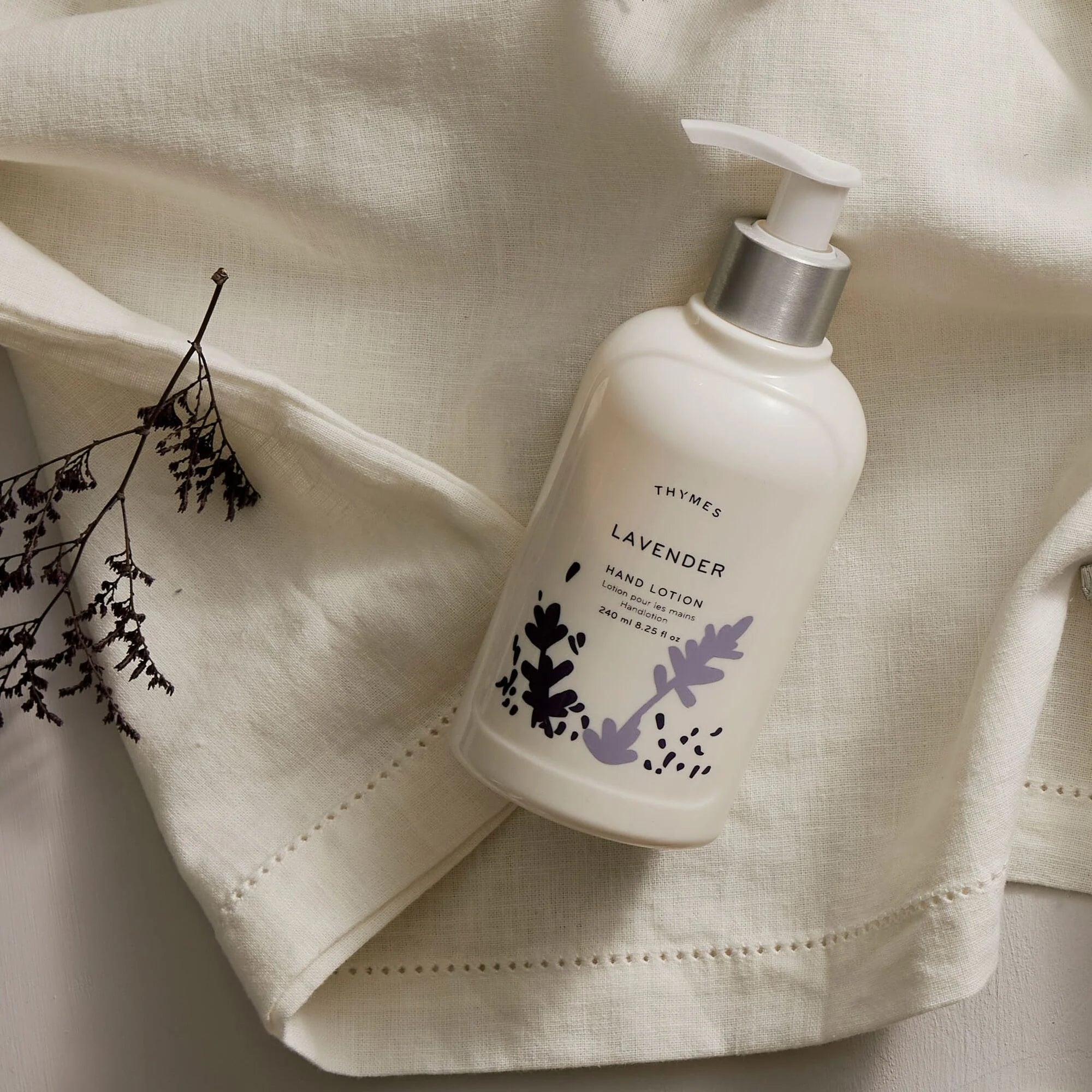 Bottle of Thyme's Lavender Hand lotion on linen