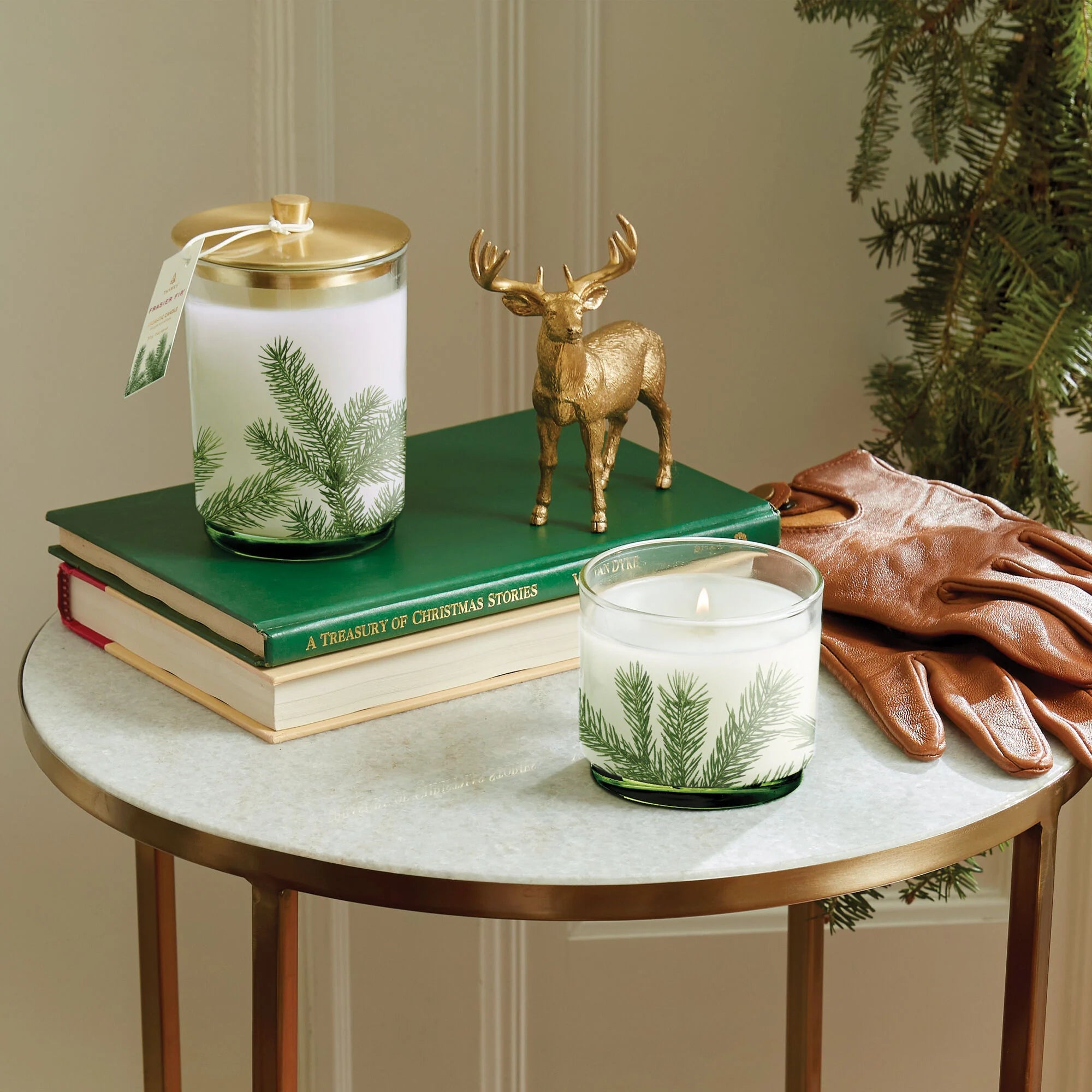 Medium and small luminary candle on table