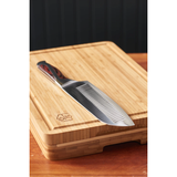 Knife with a wooden handle on a wooden cutting board