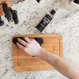 Rubbing in Caron & Doucet Cutting Board Oil onto a small cutting board