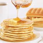 Farmhouse pancakes and waffles with syrup and  butter