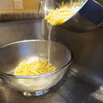 Pasta being strained through colander