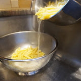 Pasta being strained through colander