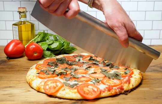 Pizza cutter cutting pizza