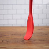 Red Silicone spoon-flexibility as shown on counter