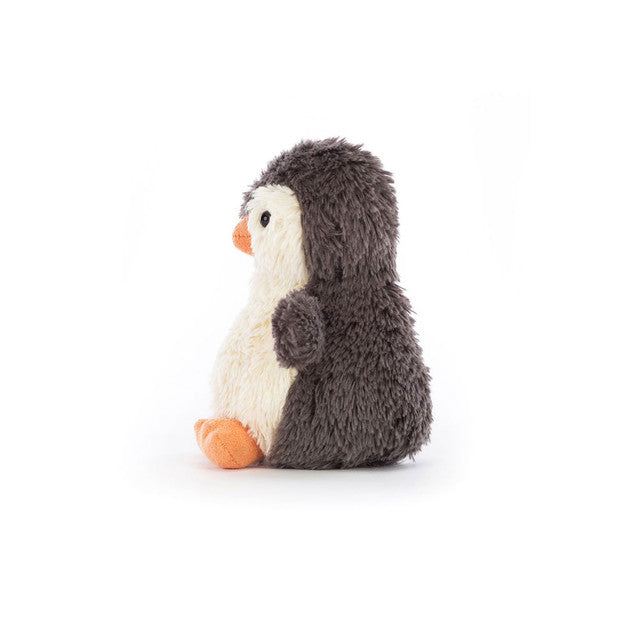 Side view of stuffed penguin on a white background