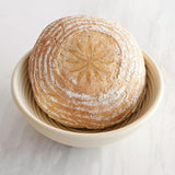 Loaf of bread in proofing basket and embossed with Talisman embosser