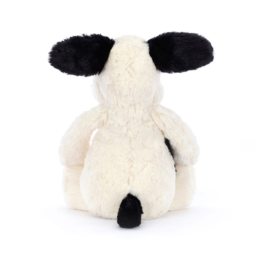Black and Cream Puppy Stuffed Animal on a white background backside