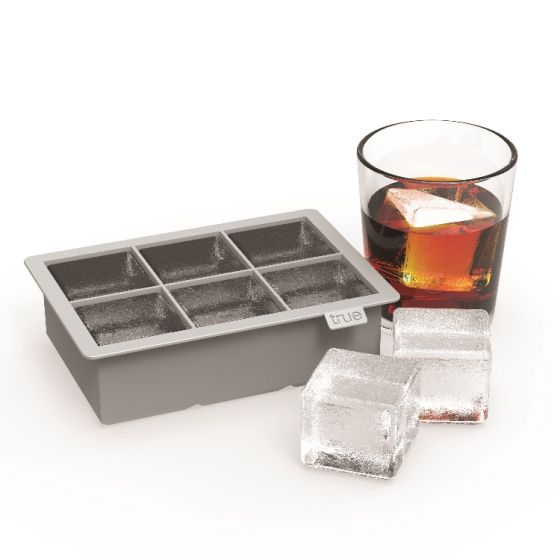 True Colossal Ice Cube Tray with a drink and ice cubes