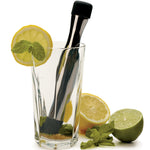 Stainless Steel Muddler crushing lemon and lime in a glass