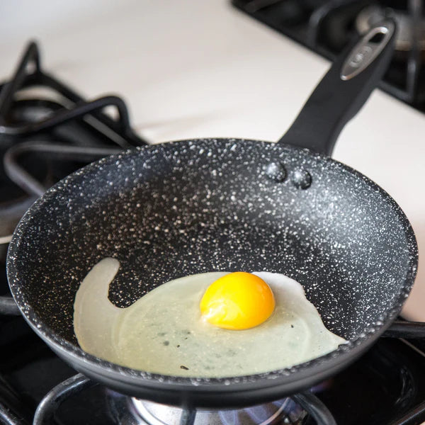 Zyliss 8" Forged Aluminum Frying Pan with egg frying in it.